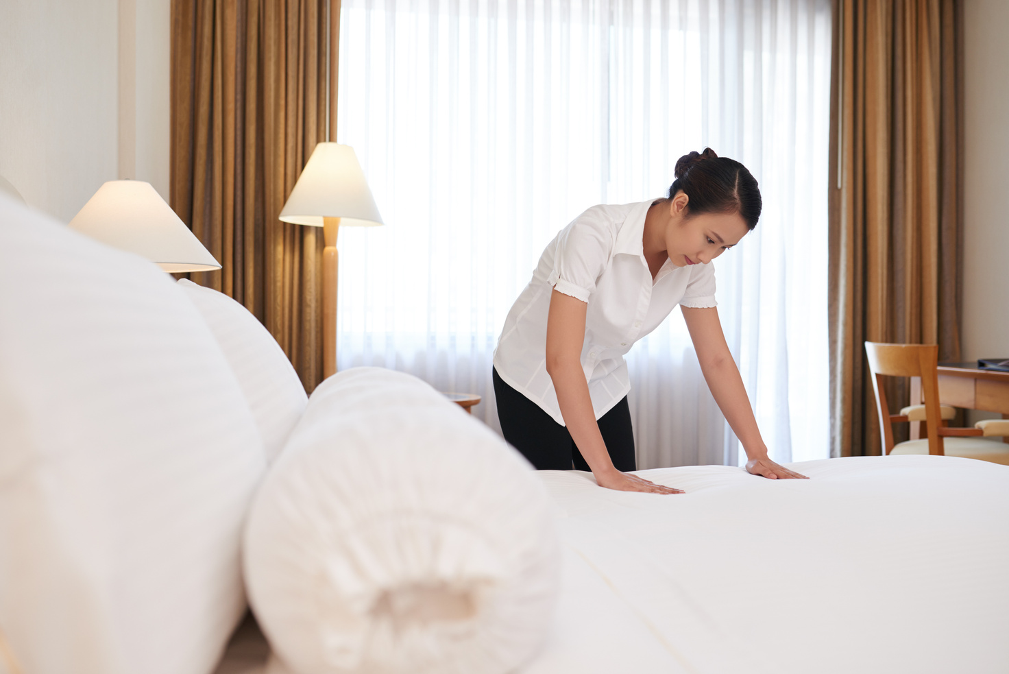 Housekeeper Changing Linen in a Hotel Room
